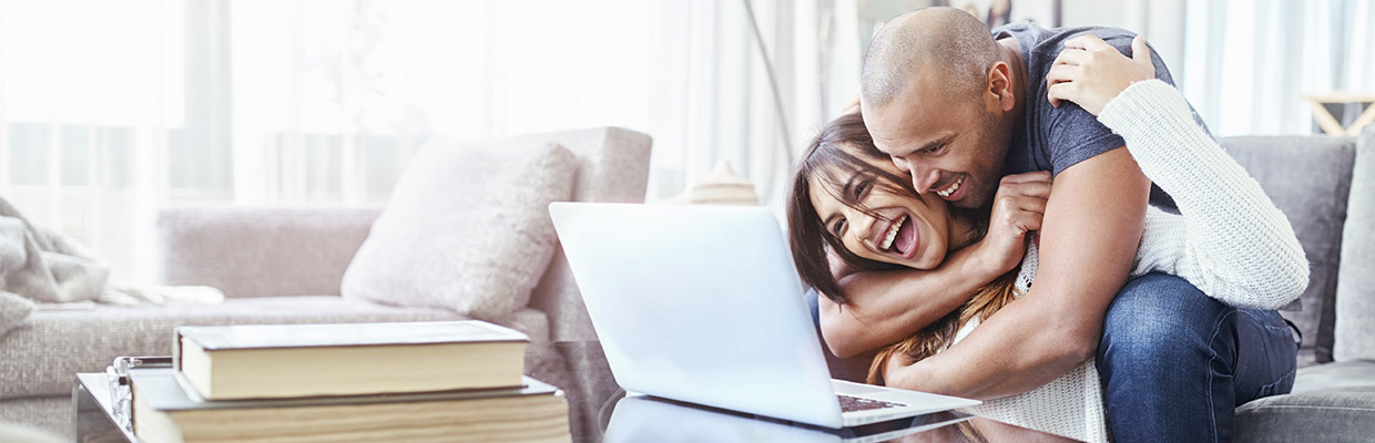 couples looking at the laptop together, image used for HSBC Mauritius Ways to bank