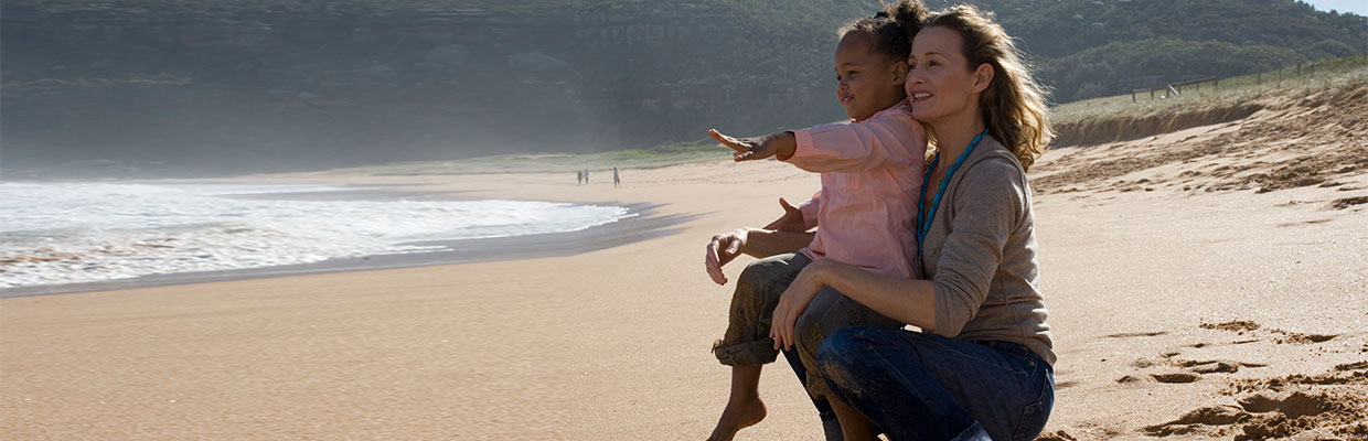 looking over beach with child; image used for HSBC Mauritius Ways to Bank Transfer Payments Page 
